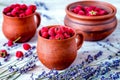 raspberry composition in pottery with dry lavender rustic backgr