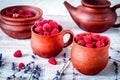 raspberry composition in pottery with dry lavender rustic backgr