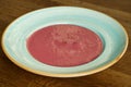 Raspberry cream soup on a wooden table Royalty Free Stock Photo