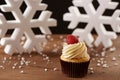 Raspberry cupcake on Christmas background