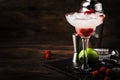 Raspberry daiquiri, alcoholic cocktail with white rum, lime juice, raspberries and crushed ice in tall glass, on wooden bar Royalty Free Stock Photo