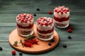 Raspberry dessert, cheesecake, trifle, mouse in a glass on a wooden background. sweet raspberry dessert
