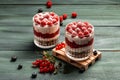 Raspberry dessert, cheesecake, trifle, mouse in a glass on a wooden background. sweet raspberry dessert