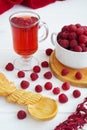 raspberry drink on a gray stone background, walls, glass cup with compote, fresh raspberries on a wooden table, cooling