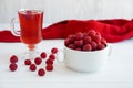 raspberry drink on a white table background, walls, glass cup with compote, fresh raspberries on a wooden table, cooling