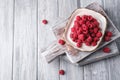 Raspberry fruits in plate on old cutting board, healthy pile of summer berries on grey wooden background Royalty Free Stock Photo