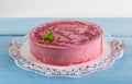 Raspberry ice cream cake on rustic blue wood Royalty Free Stock Photo