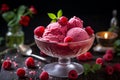 Raspberry ice cream in glass bowl with fresh raspberries and mint on black background Royalty Free Stock Photo