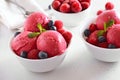 Raspberry ice cream scoop with fresh raspberries and blueberries in bowl Royalty Free Stock Photo