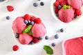 Raspberry ice cream scoop with fresh raspberries and blueberries in bowl Royalty Free Stock Photo