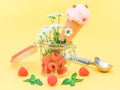 Raspberry ice cream in a waffle cone with summer flowers, fresh berries in a glass jar Royalty Free Stock Photo