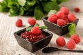 Raspberry jam marmalade in dark bowl with fresh berries and mint leaves Royalty Free Stock Photo