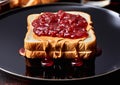 Raspberry jam and peanut butter on toasted bread on black plate.Macro.AI Generative