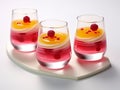raspberry jelly decorated with panna cotta drizzle and mint leaves, on a white background