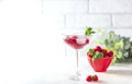 Raspberry lemonade with mint and ice in a glass on a light concrete background Royalty Free Stock Photo