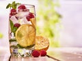 Raspberry mojito with cubes ice glass. Outdoor.