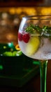 Raspberry Mojito Lemonade with lime and fresh mint in glass on wooden background. Royalty Free Stock Photo