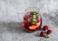 Raspberry, peach, mint cocktail lemonade refreshing drink on a gray background Royalty Free Stock Photo