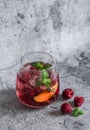 Raspberry, peach, mint cocktail lemonade refreshing drink on a gray background. Summer cool drinks Royalty Free Stock Photo