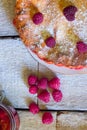 Raspberry pie with fresh raspberries and jam on white wooden background. Top view.