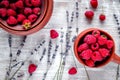 Raspberry in pottery and lavender flowers on rustic background t