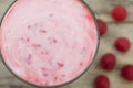 Raspberry smoothie with berries on wooden background. Healthy vegetarian food