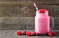 Raspberry smoothie in a mason jar with berries against wood Royalty Free Stock Photo