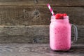 Raspberry smoothie in a mason jar against rustic wood Royalty Free Stock Photo