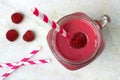 Raspberry smoothie in a mason jar with straws Royalty Free Stock Photo