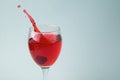 Raspberry splashing into glass of wine red juice drink splash water drop on white background Royalty Free Stock Photo