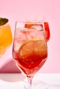 Raspberry spritz cocktail. Pink background