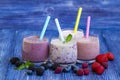 Raspberry, strawberry and blueberry smoothie on blue wooden background. milkshake with fresh berries. berry yogurt with Royalty Free Stock Photo