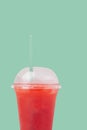 Raspberry syrup cocktail in take away cup with straw over white background