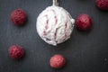 Raspberry-vanilla-icecream in icecream scoop, fresh raspberries on slate