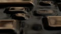 Raster golden texture, gold level lines pattern, curved square rounded metal plates background with reflection. Abstract