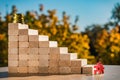 Rat race concept. Fight for promotion. Two puzzles are racing on the way to the top of the stairs made of wooden blocks. Blurry