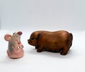 The rat is a symbol of the new year 2020 and the pig is a symbol of year 2019 are staying near christmas toys on the