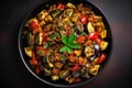 Ratatouille bowl made of eggplant, zucchini, pepper, onion and tomato