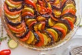 Ratatouille: Colorful layers of fresh summer vegetables: zucchini, eggplant, tomatoes on tomato sauce season with garlic and  fres Royalty Free Stock Photo