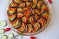 Ratatouille: Colorful layers of fresh summer vegetables: zucchini, eggplant, tomatoes on tomato sauce season with garlic and  fres Royalty Free Stock Photo