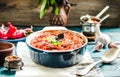 Ratatouille on rustic background, baked vegetables in tomato sauce with basil and paprika