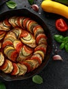 Ratatouille Vegetable Stew with zucchini, eggplants, tomatoes, garlic, onion and basil. on cast iron pan. Traditional French food