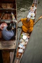 Ratchaburi thailand - january12,2019 : thai monk receiving food from thai woman offering in dumneon saduak canal one of most