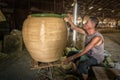 Local artisans crafting Thai-style dragon jars in factory at Ratchaburi, Thailand