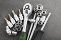 Ratchet set with heads, different socket wrenches close-up on a dark stone Royalty Free Stock Photo