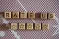 Rate us inscription and stars on wooden cubes