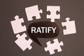 RATIFY - word on a black note against the background of white puzzles Royalty Free Stock Photo
