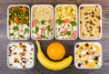 Ration of balanced food in plastic containers on dark table