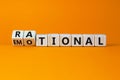 Rational or emotional symbol. Turned wooden cubes and changed the word `rational` to `emotional`. Beautiful orange background. Royalty Free Stock Photo