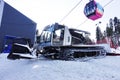 Ratrak on ski slope with pink cable car on background Royalty Free Stock Photo